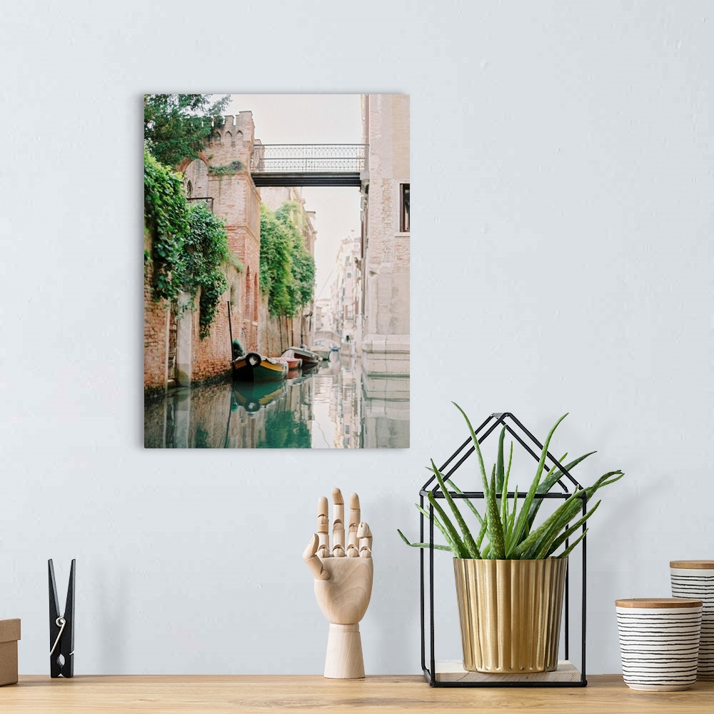 A bohemian room featuring Photograph of small boats moored beneath an old brick wall, Venice, Italy.