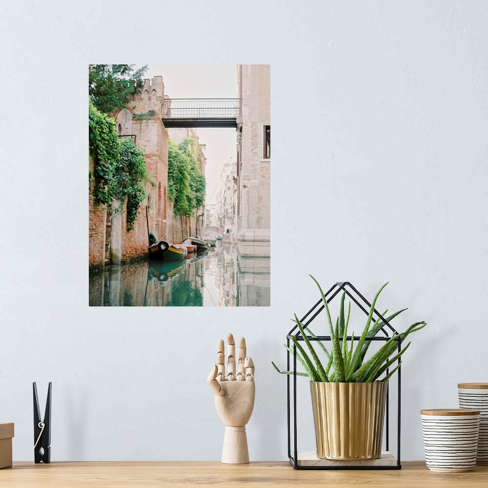 A bohemian room featuring Photograph of small boats moored beneath an old brick wall, Venice, Italy.