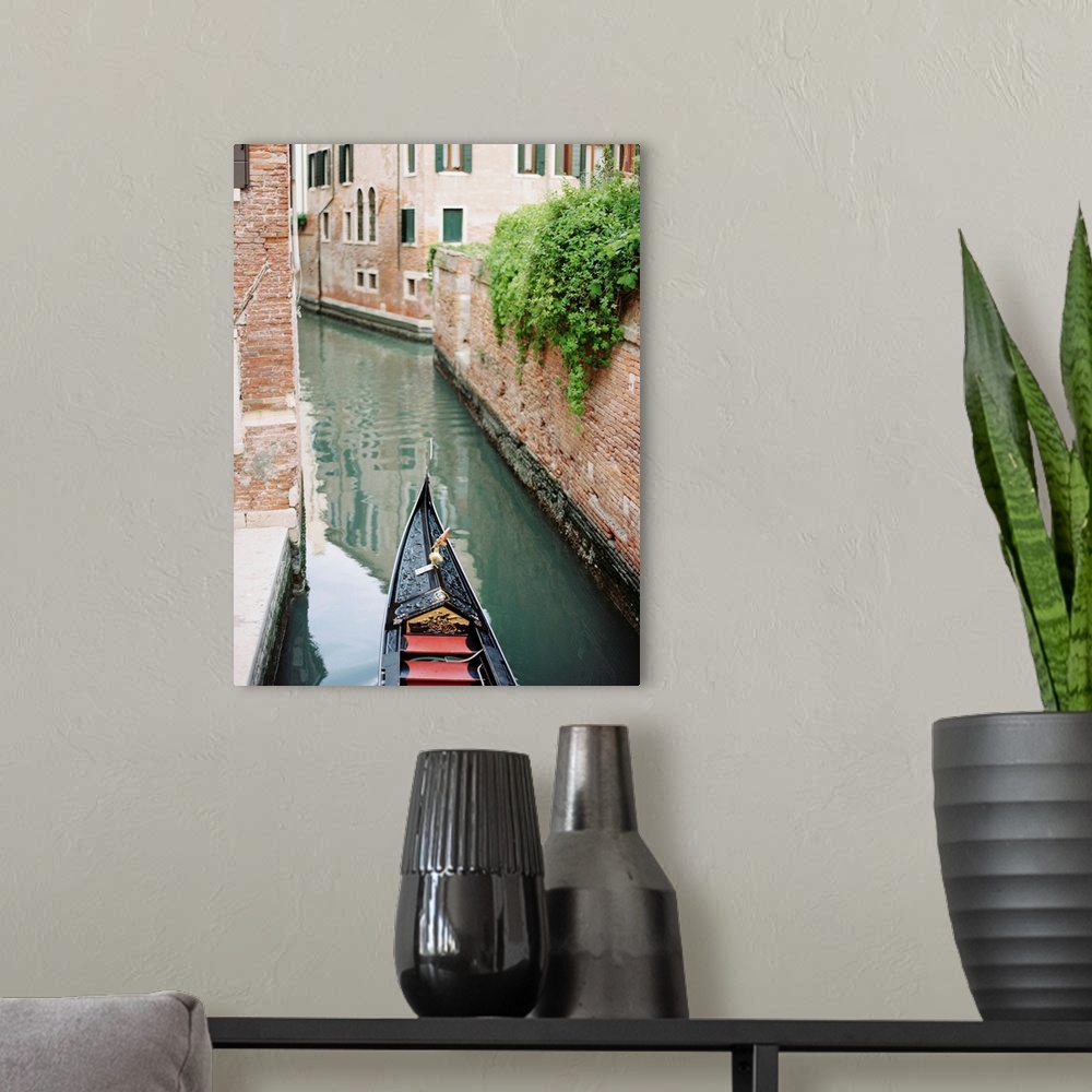 A modern room featuring Photograph of the front of a gondola on the water, Venice, Italy.