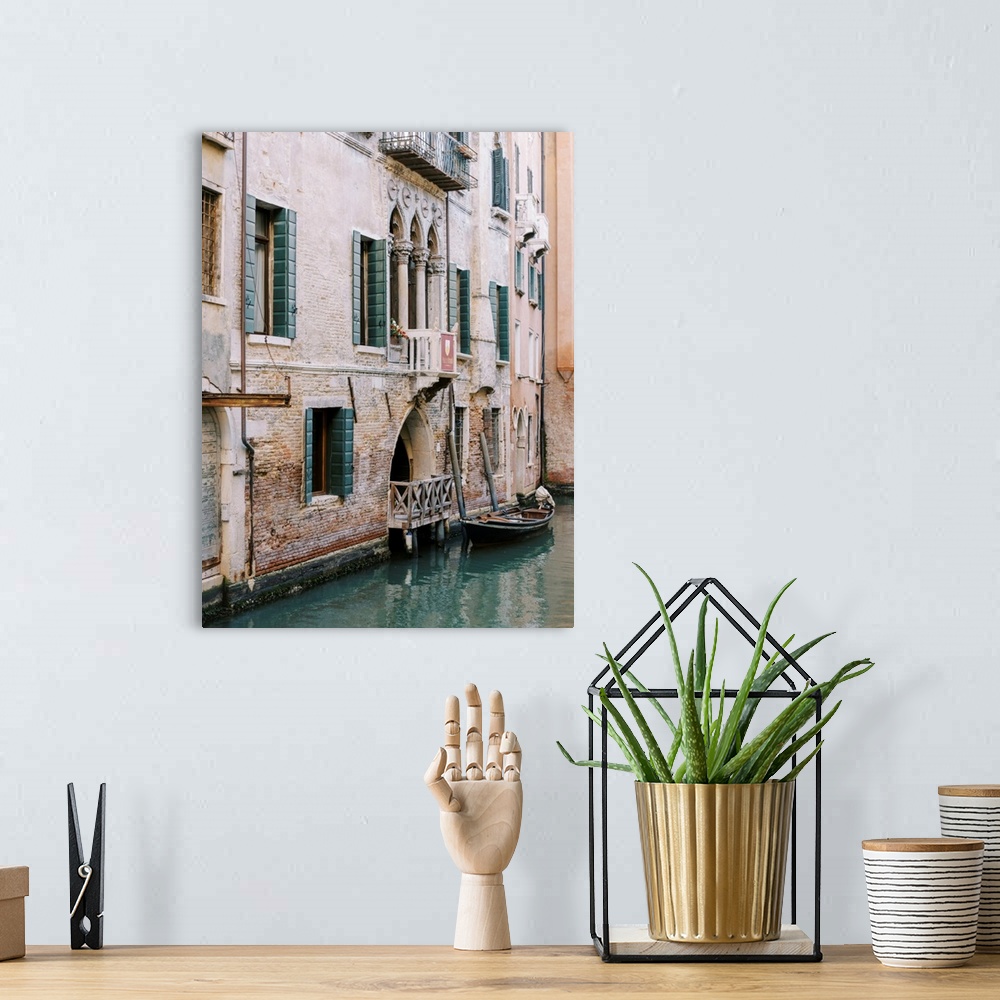 A bohemian room featuring A photograph of the facade of a house on a canal, Venice, Italy.