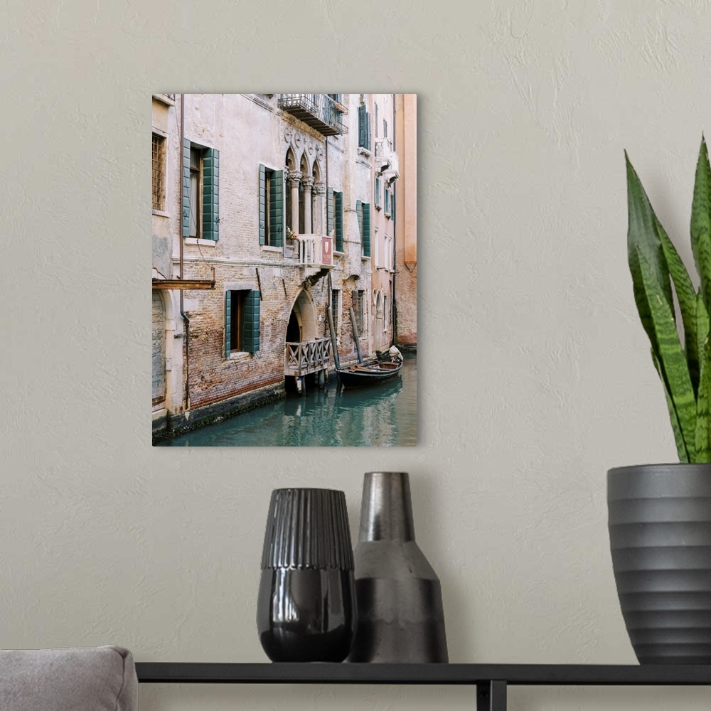 A modern room featuring A photograph of the facade of a house on a canal, Venice, Italy.