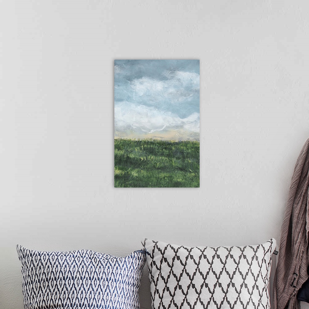 A bohemian room featuring Vertical painting of a green field and cloud filled blue sky.