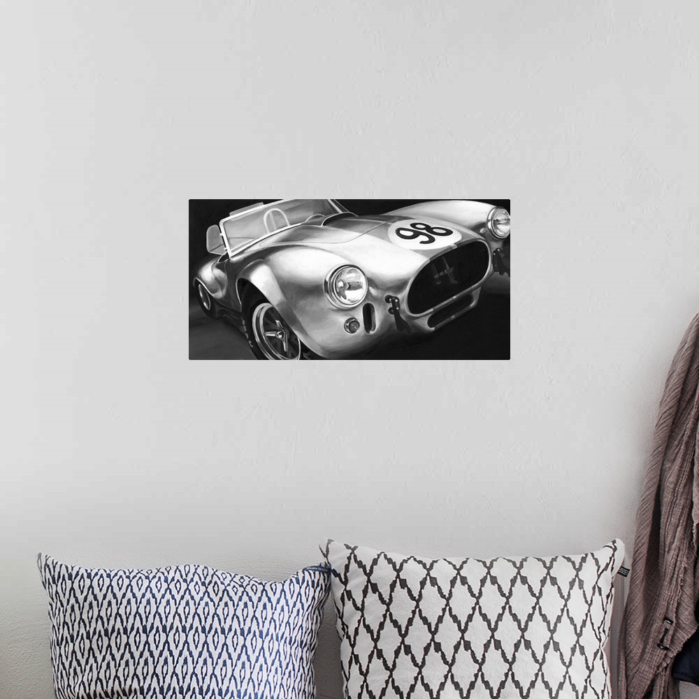 A bohemian room featuring Photograph of classic muscle car with a convertible top and a 98 emblem circle on the hood.