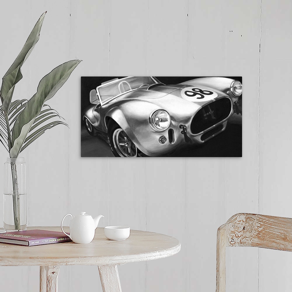 A farmhouse room featuring Photograph of classic muscle car with a convertible top and a 98 emblem circle on the hood.