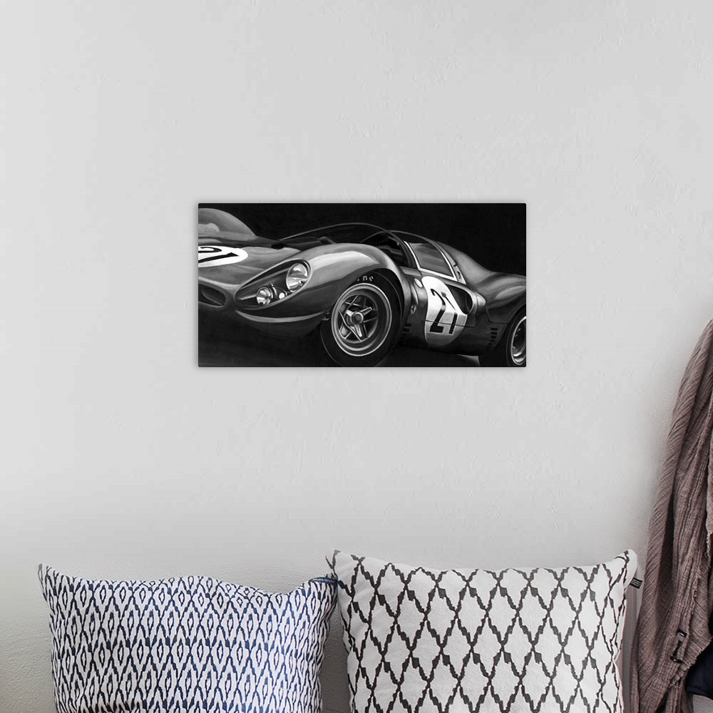 A bohemian room featuring Landscape, large vintage art in black and white of the side view of a rounded race car with the n...
