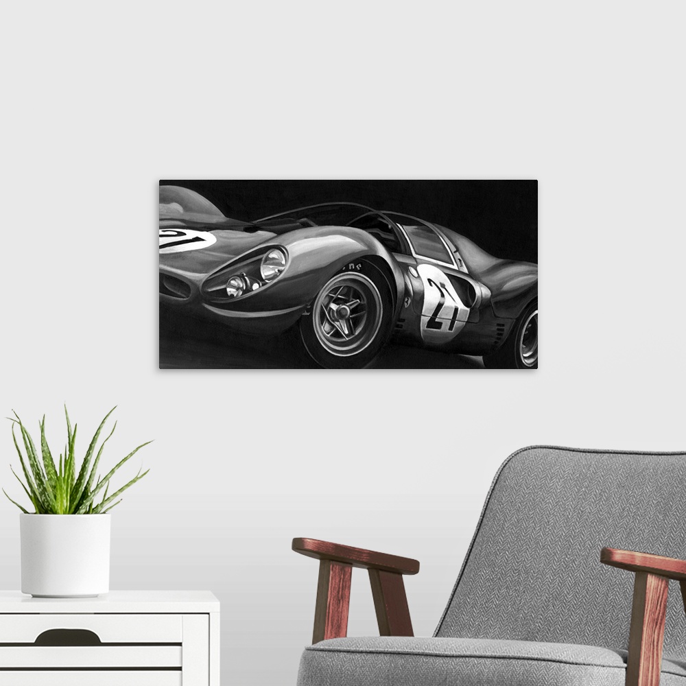 A modern room featuring Landscape, large vintage art in black and white of the side view of a rounded race car with the n...