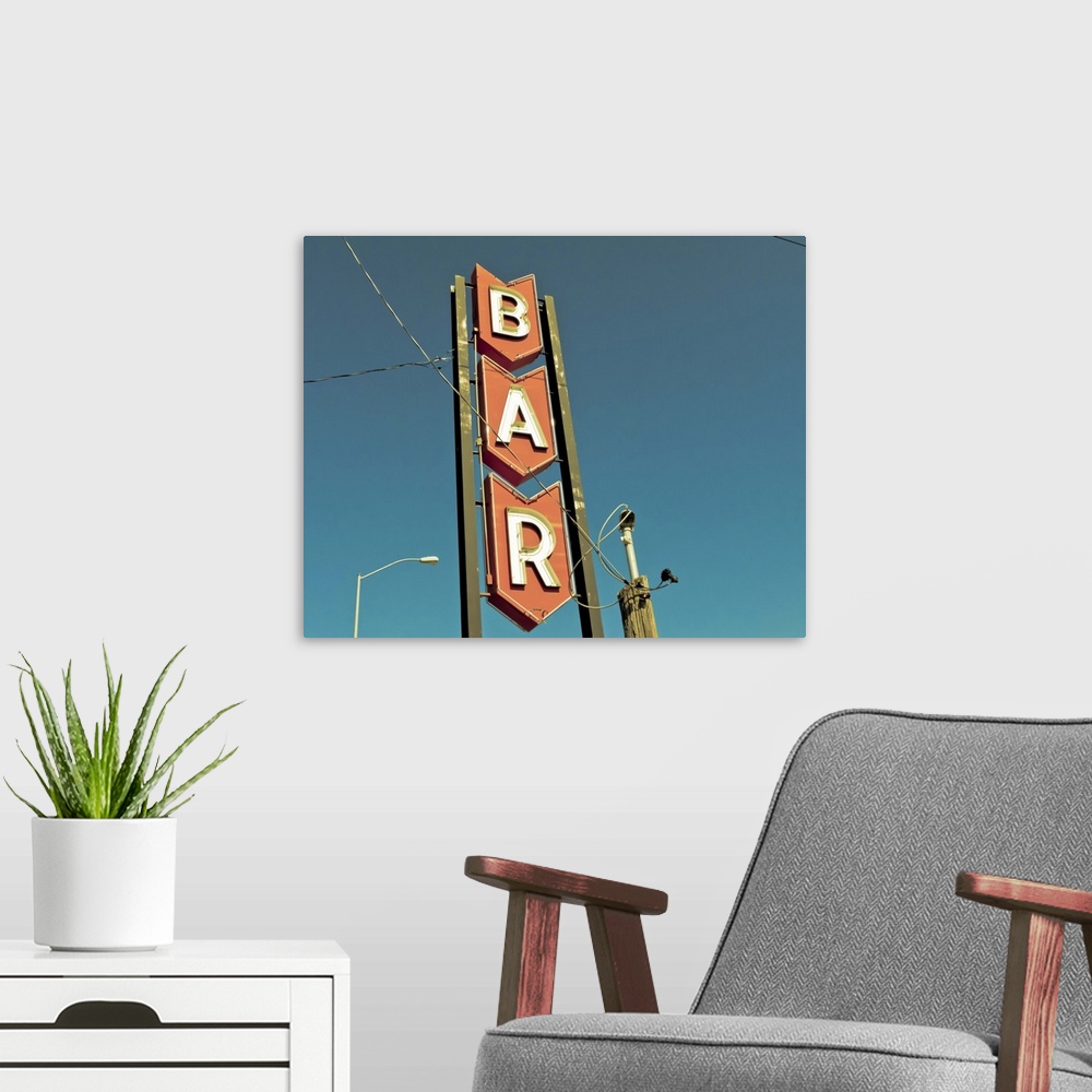 A modern room featuring Photograph of mid-century bar sign against a blue sky.
