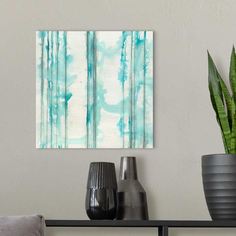 A modern room featuring Square abstractly painted canvas of vertical lines with splattered watercolor paint on top.