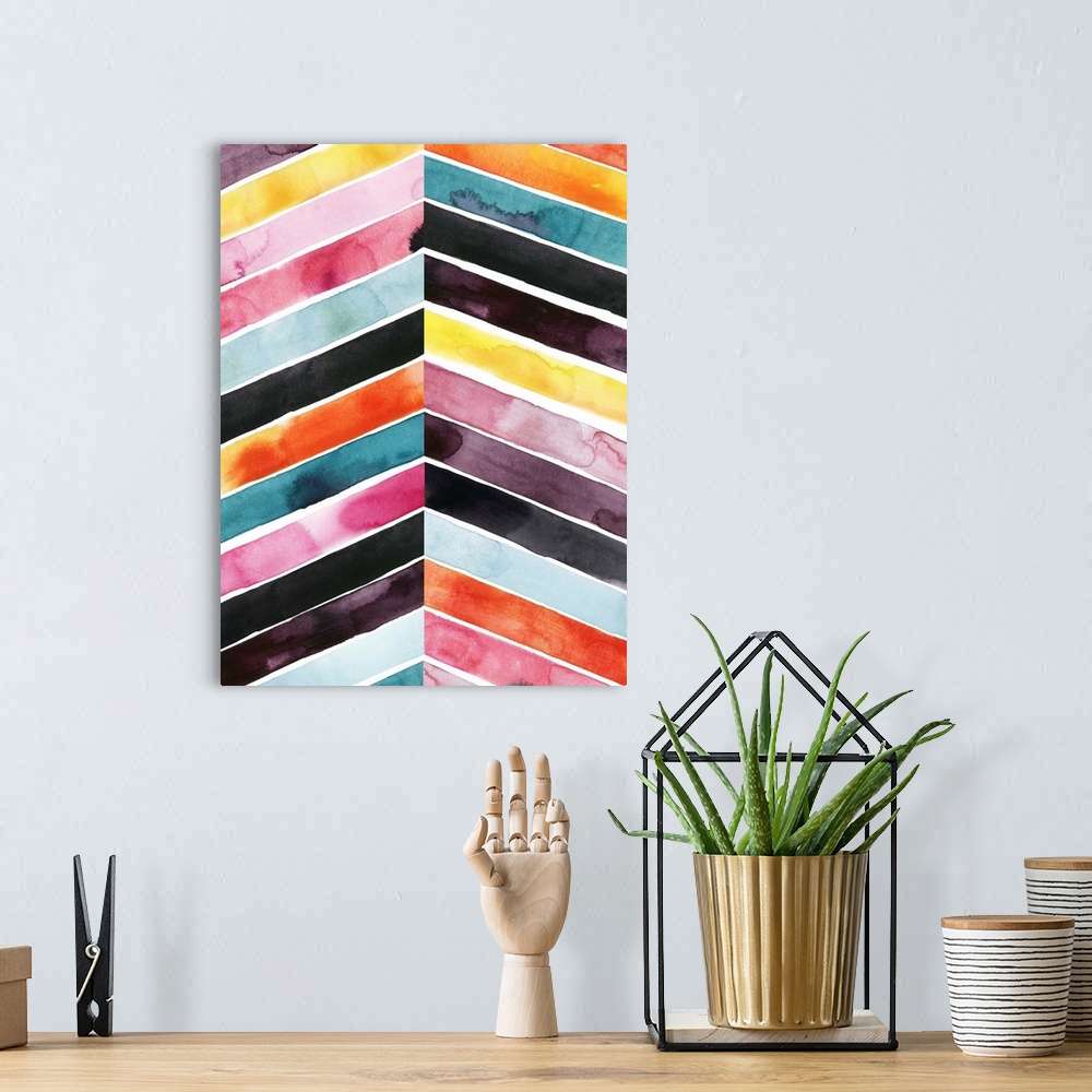 A bohemian room featuring Chevron striped watercolor painting in vivid red, pink, blue, and yellow contrasting with black.