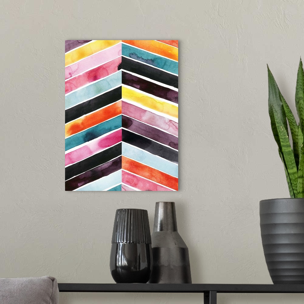 A modern room featuring Chevron striped watercolor painting in vivid red, pink, blue, and yellow contrasting with black.