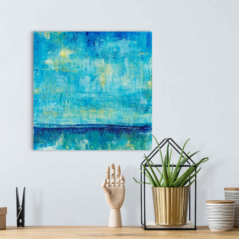 A bohemian room featuring Abstract artwork of an ocean horizon in shades of teal and gold.