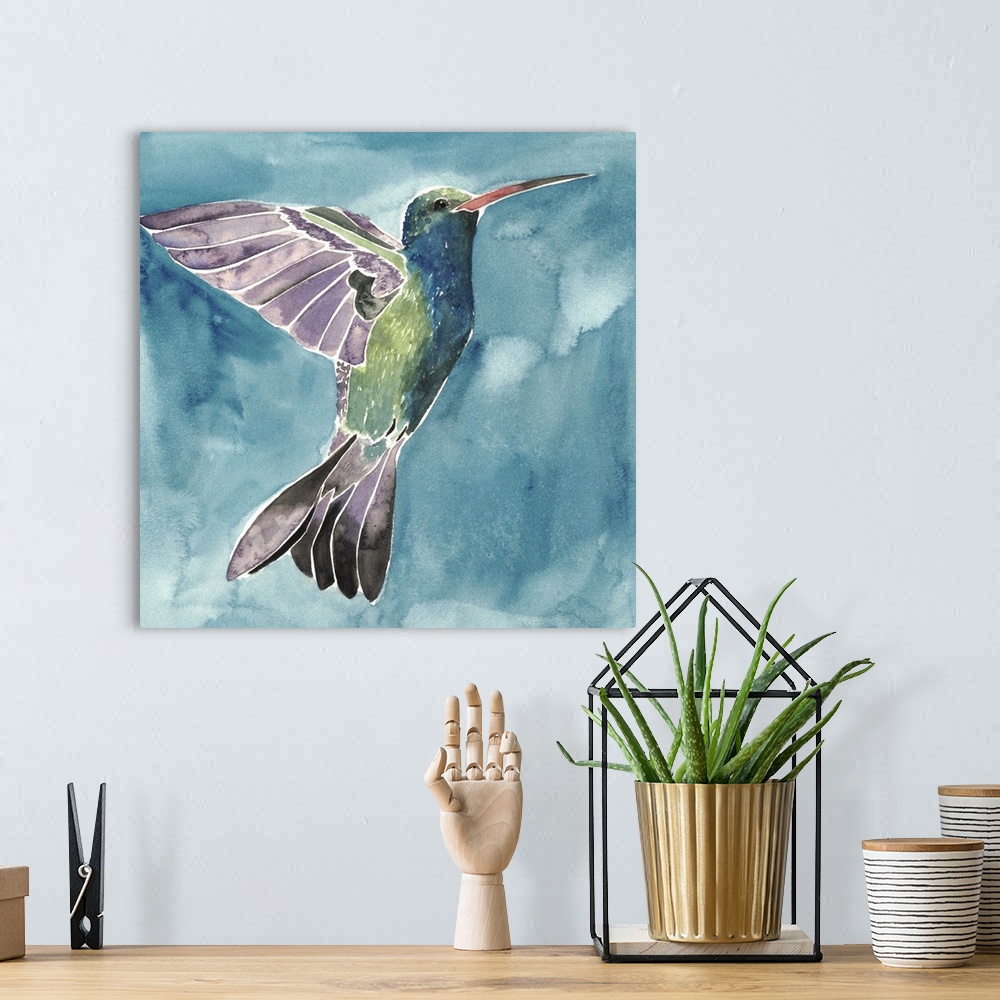 A bohemian room featuring Watercolor painting of a hummingbird against a blue background.