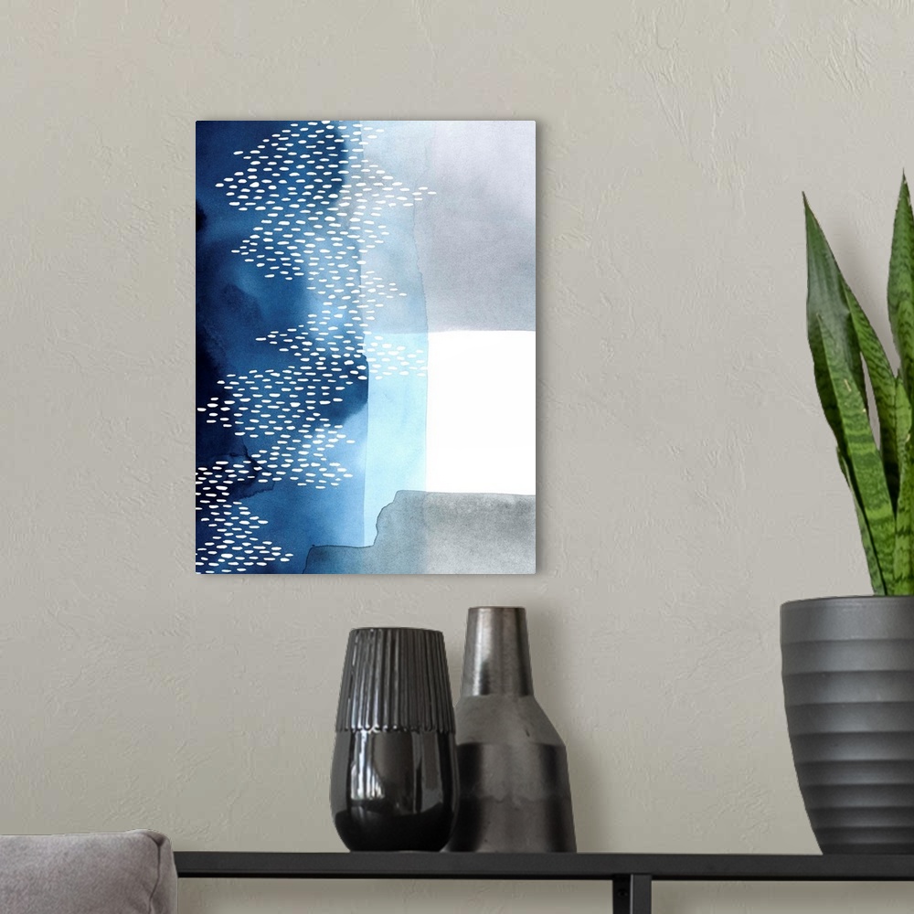 A modern room featuring Abstract watercolor painting of blocks of blue and grey color with a white dot pattern.