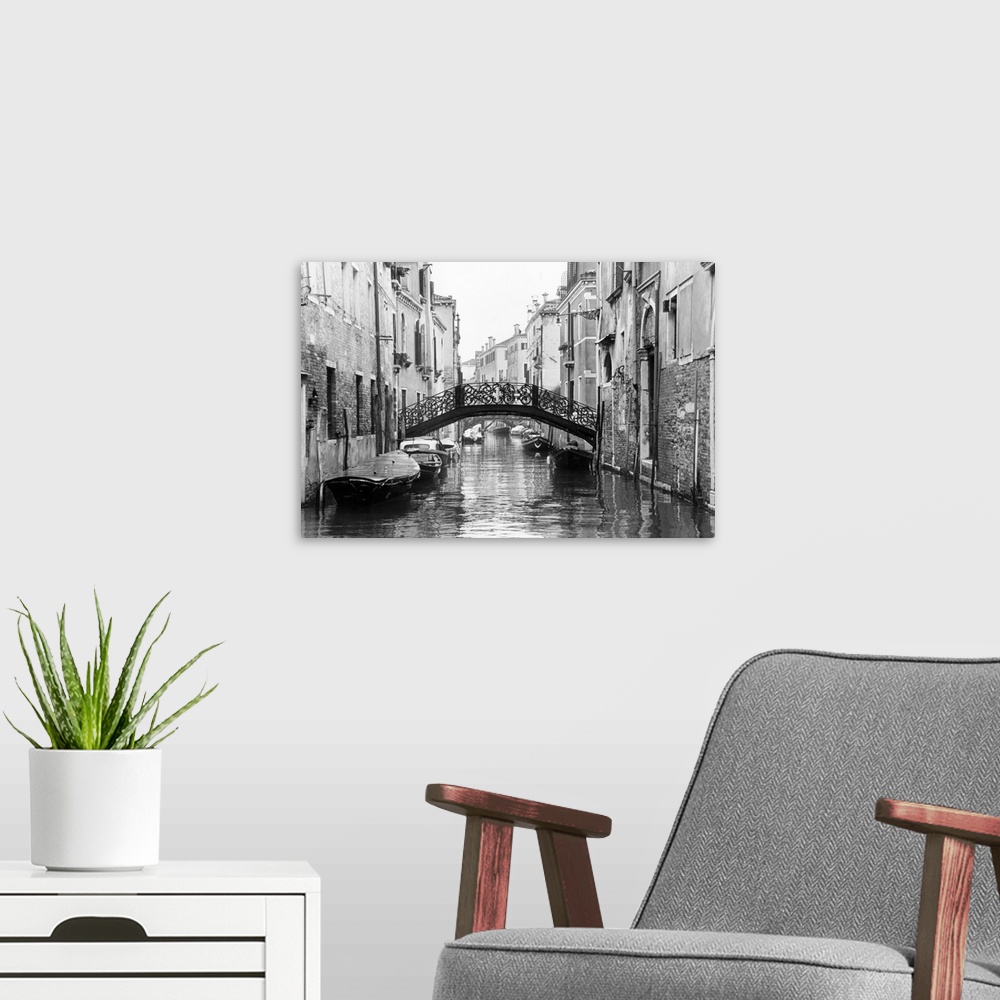 A modern room featuring Large photo on canvas of gondolas lining a canal in Venice.