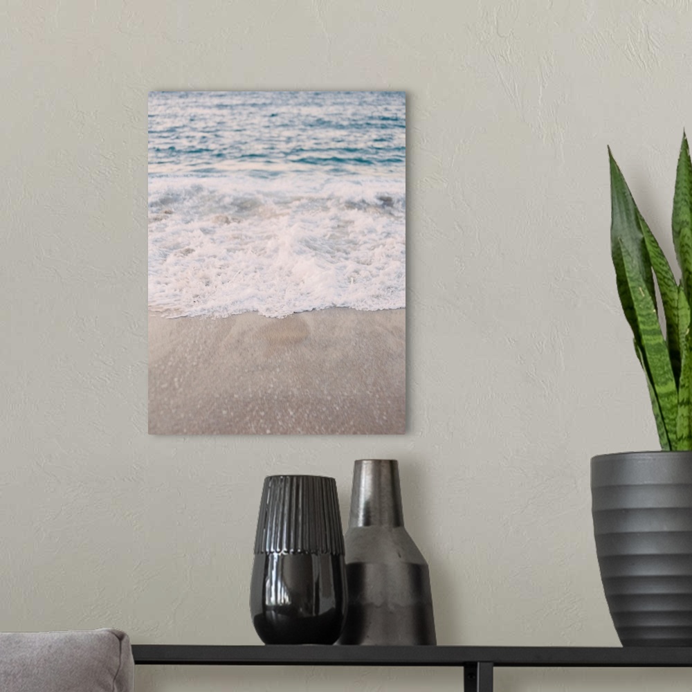 A modern room featuring A photograph of waves lapping the beach.