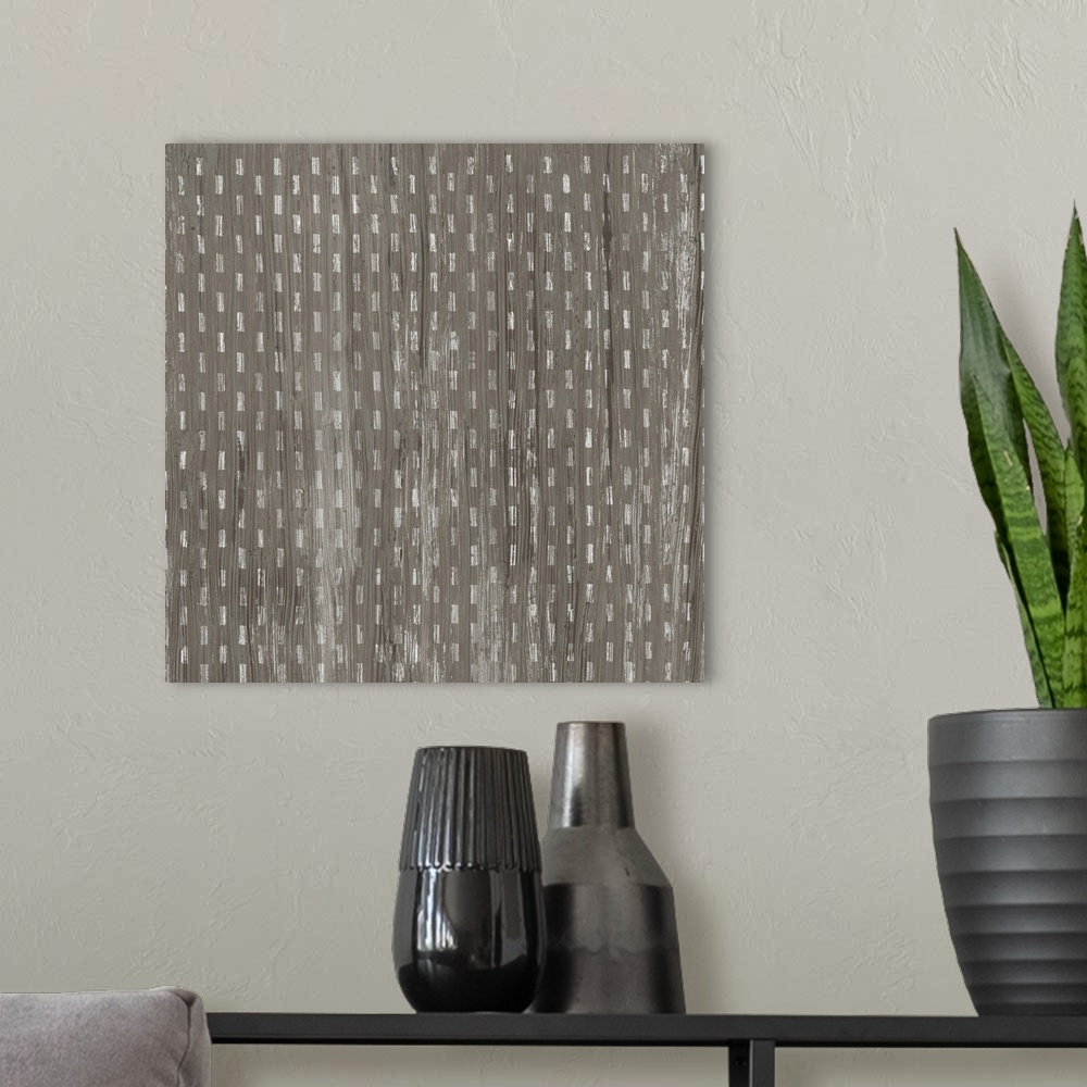 A modern room featuring Square decorative artwork of a repetitive small lines with a light streak overlay.