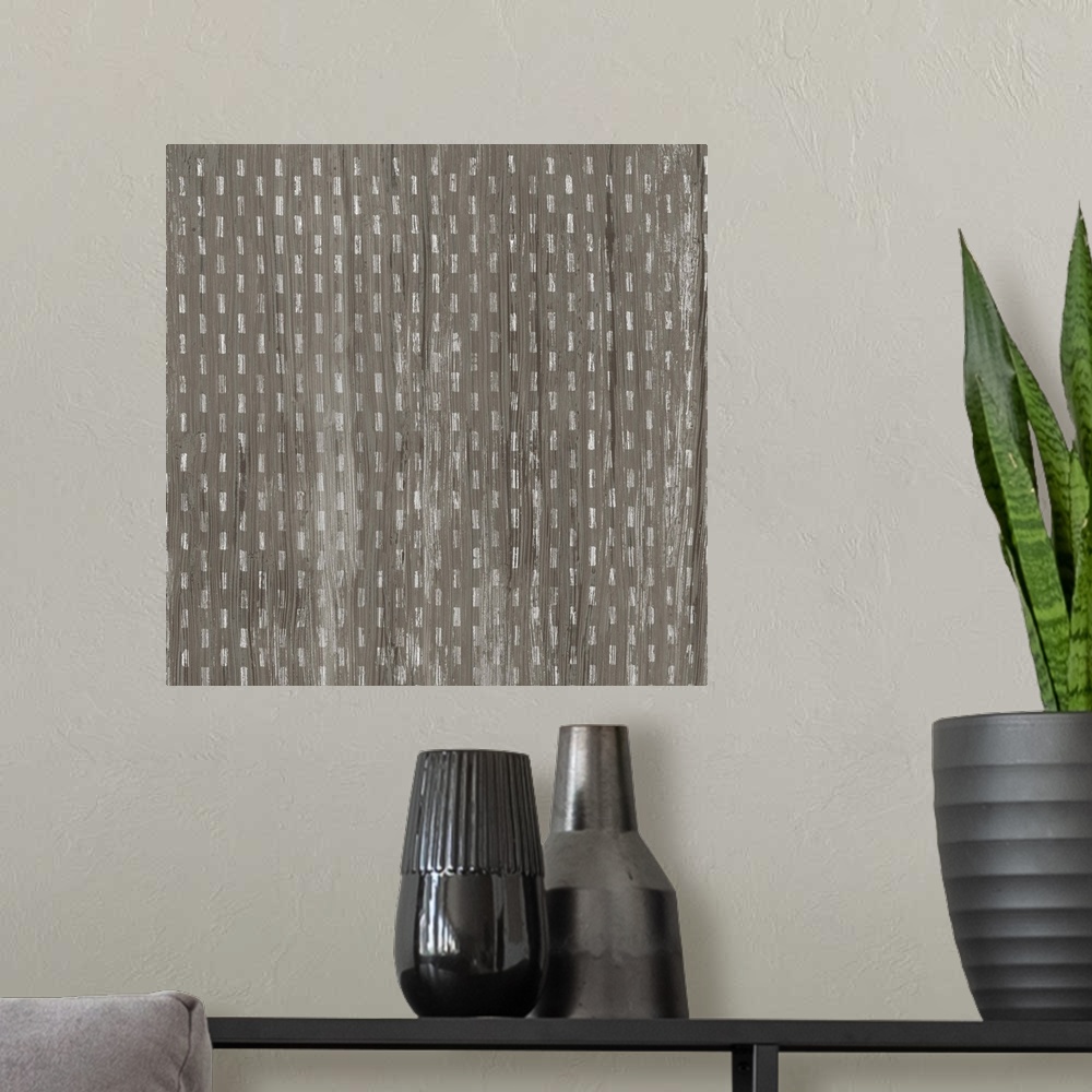 A modern room featuring Square decorative artwork of a repetitive small lines with a light streak overlay.