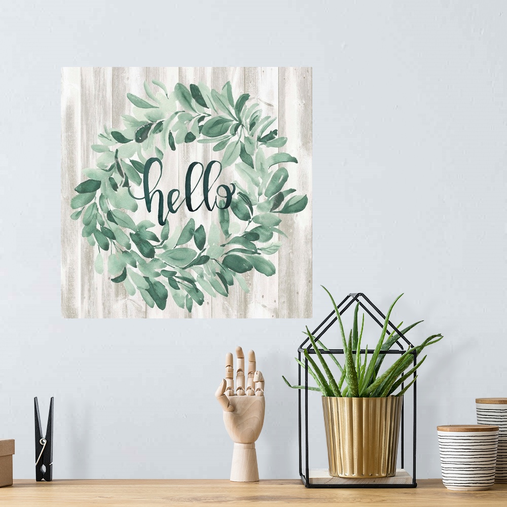 A bohemian room featuring Watercolor wreath painting with script "Hello" in center.