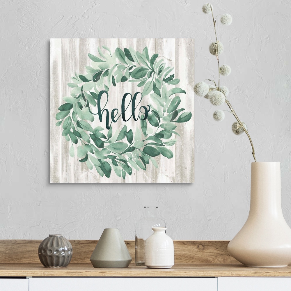 A farmhouse room featuring Watercolor wreath painting with script "Hello" in center.