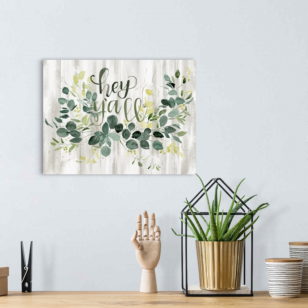 A bohemian room featuring Watercolor "Hey Y'all" sign with green flora decoration on a shiplap painted background.
