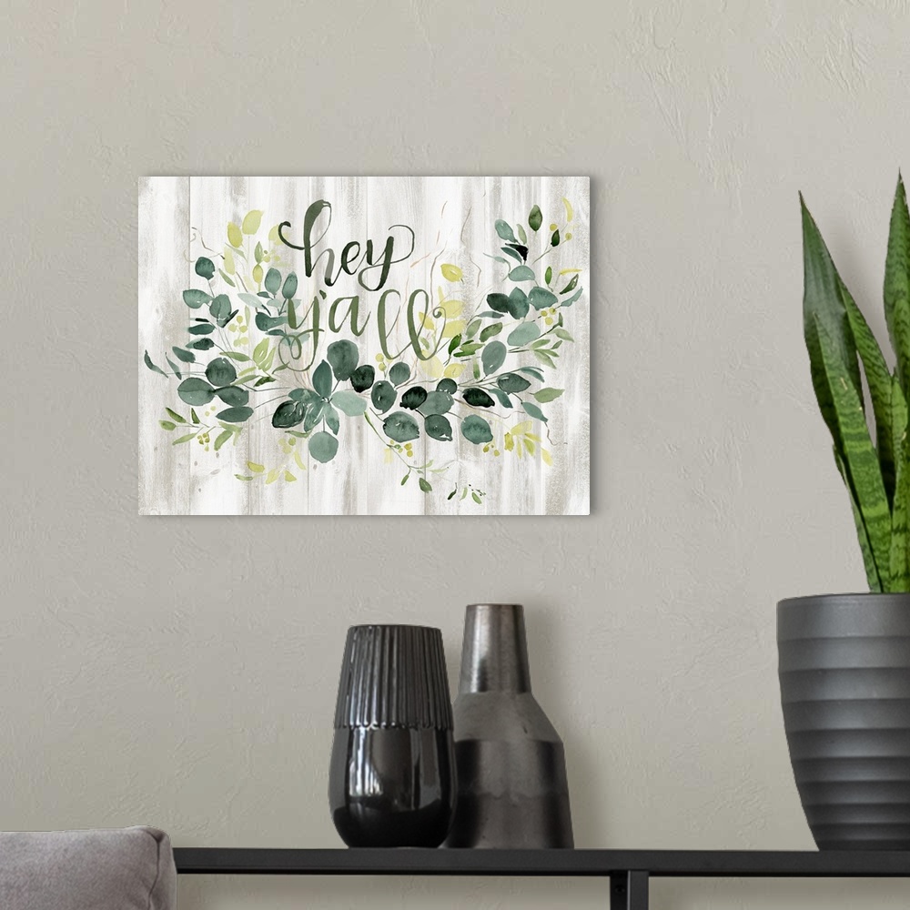 A modern room featuring Watercolor "Hey Y'all" sign with green flora decoration on a shiplap painted background.
