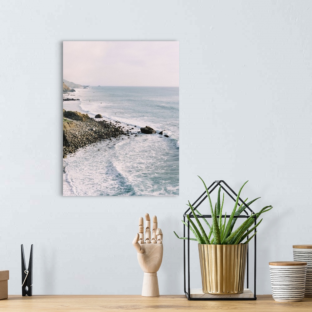A bohemian room featuring Photograph of gentle waves lapping the rocky shore of Big Sur, California.