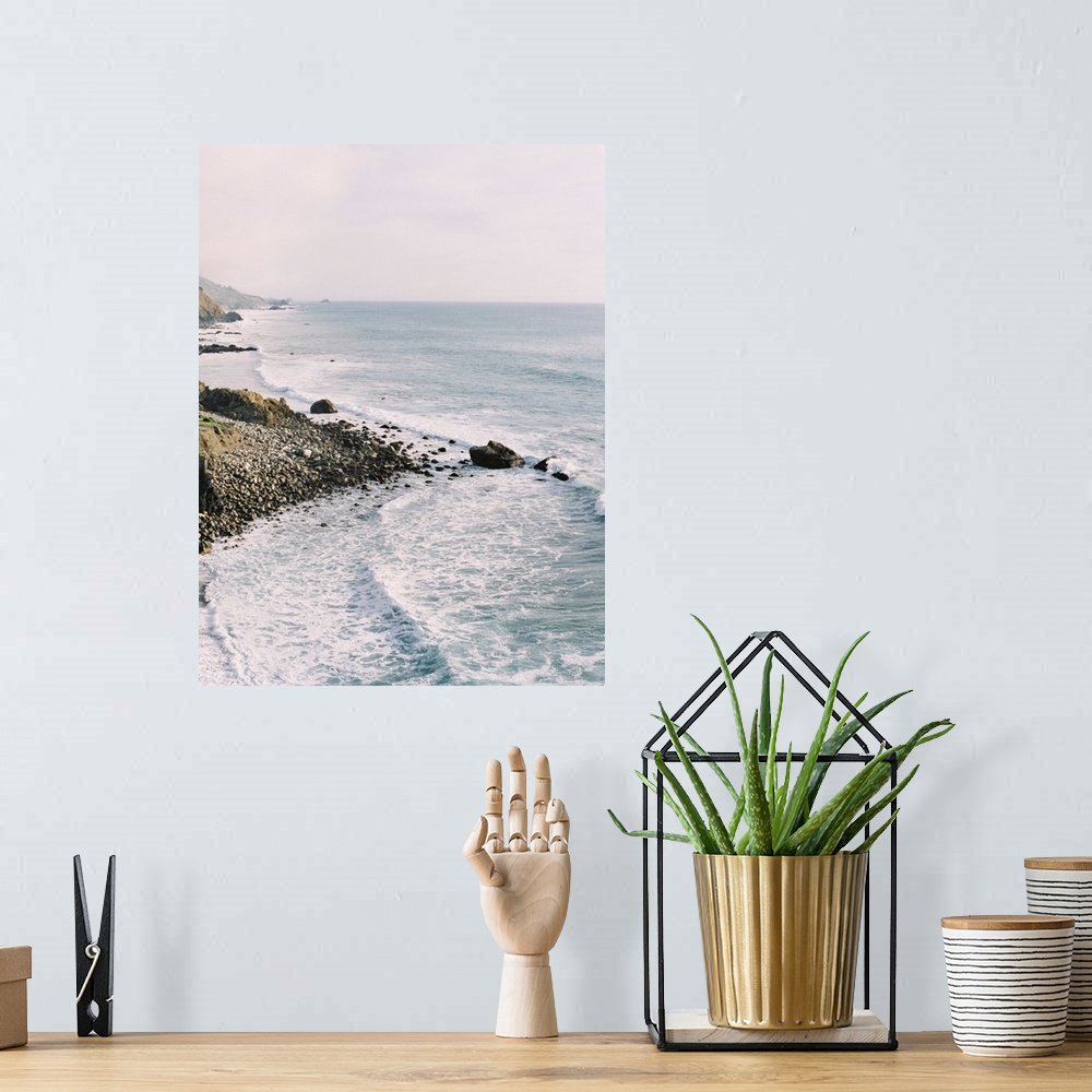 A bohemian room featuring Photograph of gentle waves lapping the rocky shore of Big Sur, California.