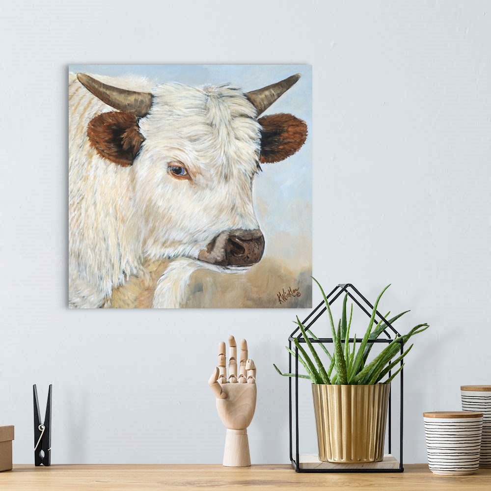 A bohemian room featuring Contemporary painting of a portrait of a white cow with large ears and short horns.