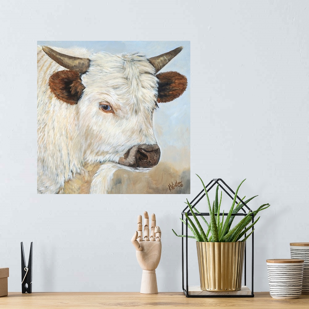 A bohemian room featuring Contemporary painting of a portrait of a white cow with large ears and short horns.