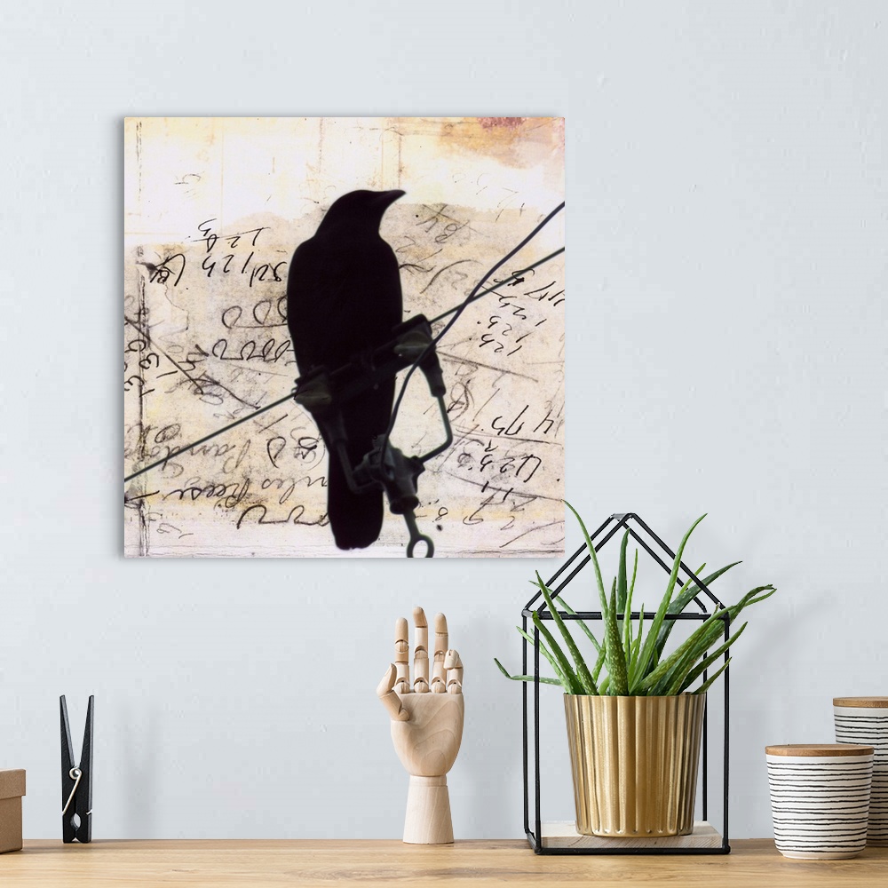 A bohemian room featuring Artwork of a silhouetted crow perched on a wire against a scribbled weathered piece of paper.