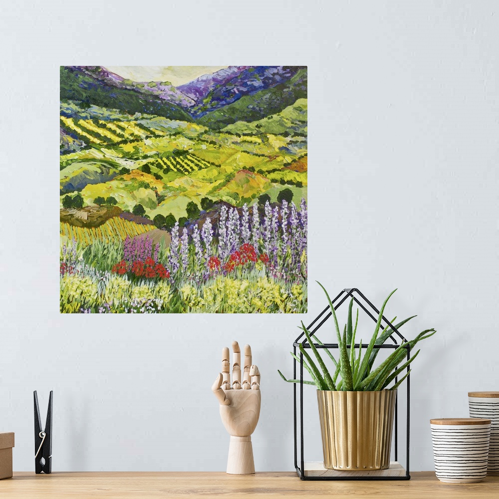 A bohemian room featuring Contemporary painting of a country landscape with wildflowers in the foreground and farmland in t...