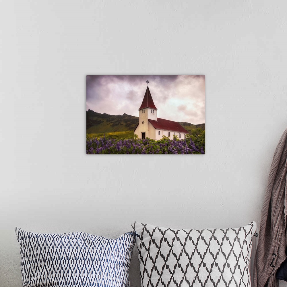 A bohemian room featuring In this photo, a storm begins to brew above a peaceful church near a field of lavender.