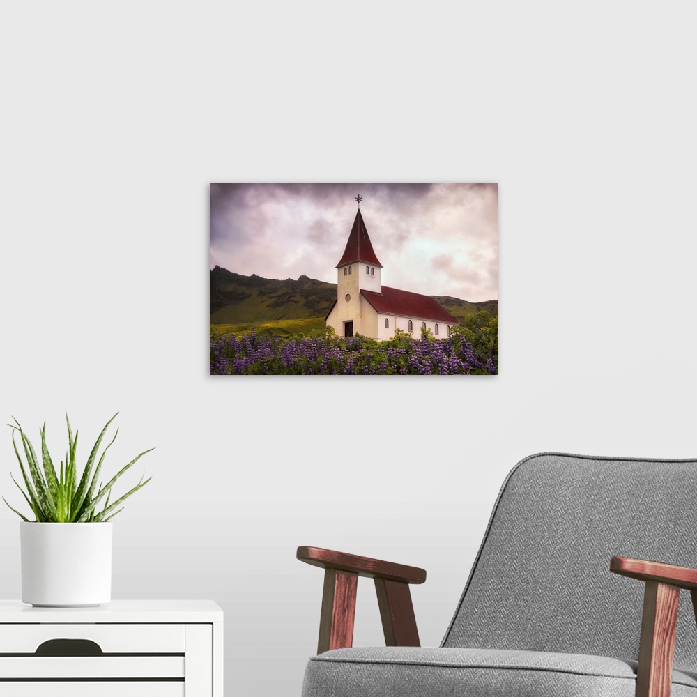 A modern room featuring In this photo, a storm begins to brew above a peaceful church near a field of lavender.