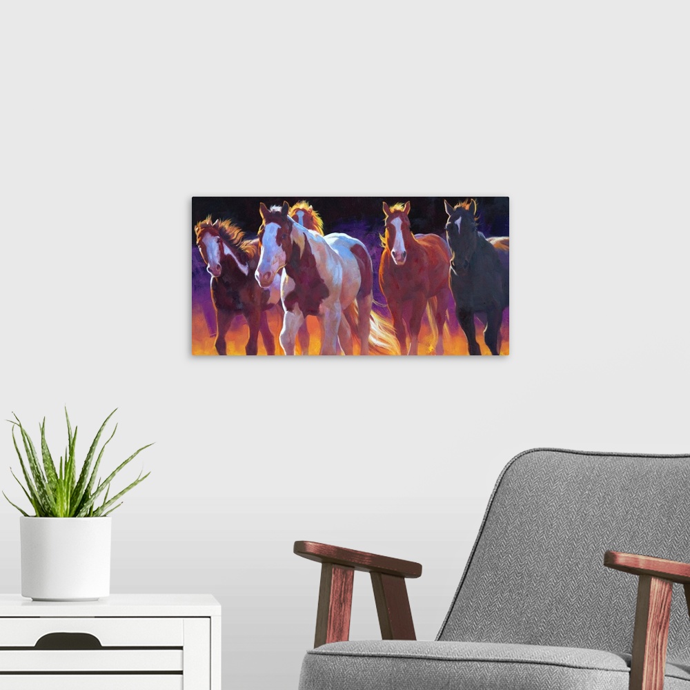A modern room featuring Contemporary painting of wild horses running with a dark purple and orange background.