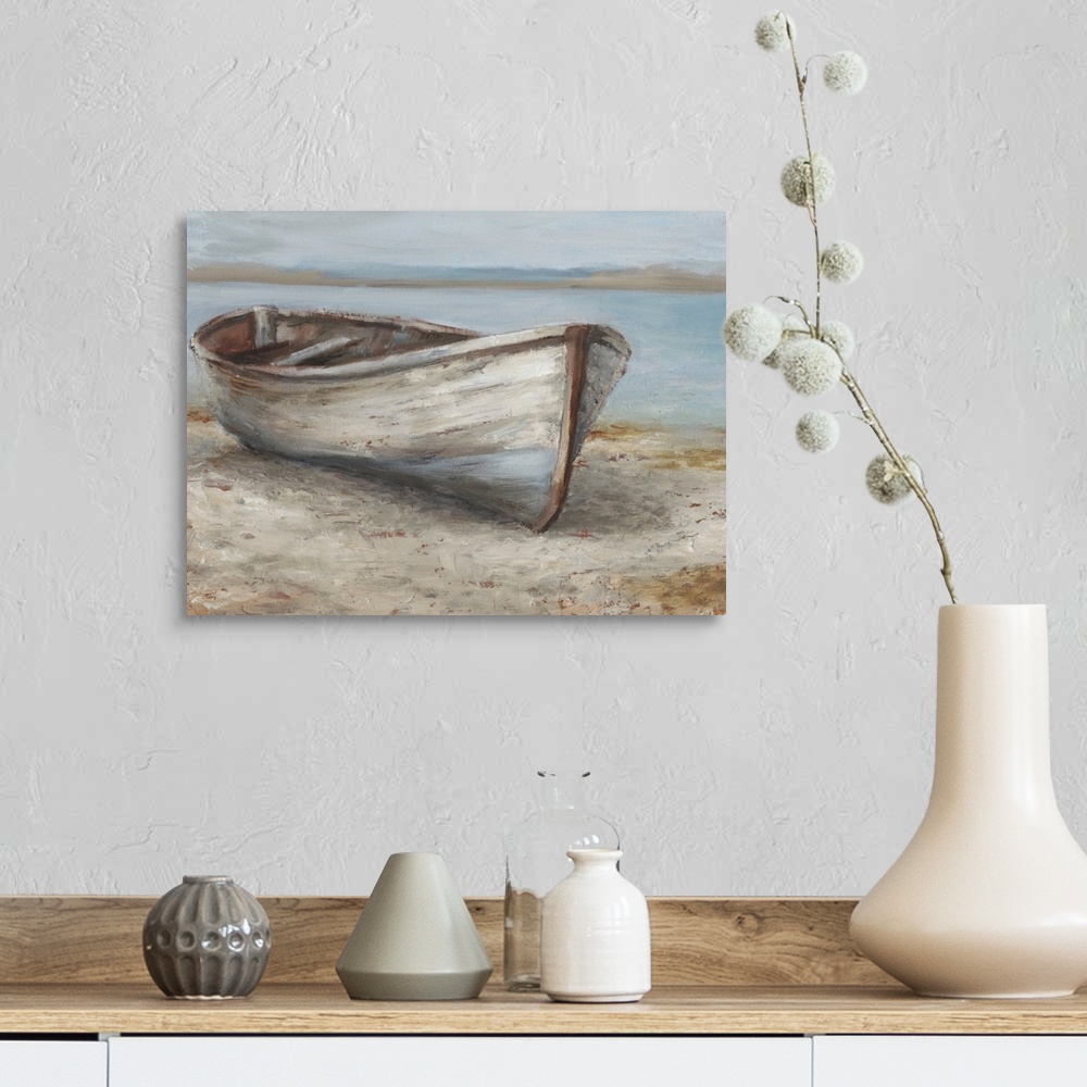 A farmhouse room featuring A tranquil, coastal scene of an old wooden rowboat pulled up onto the sand. It features neutral t...