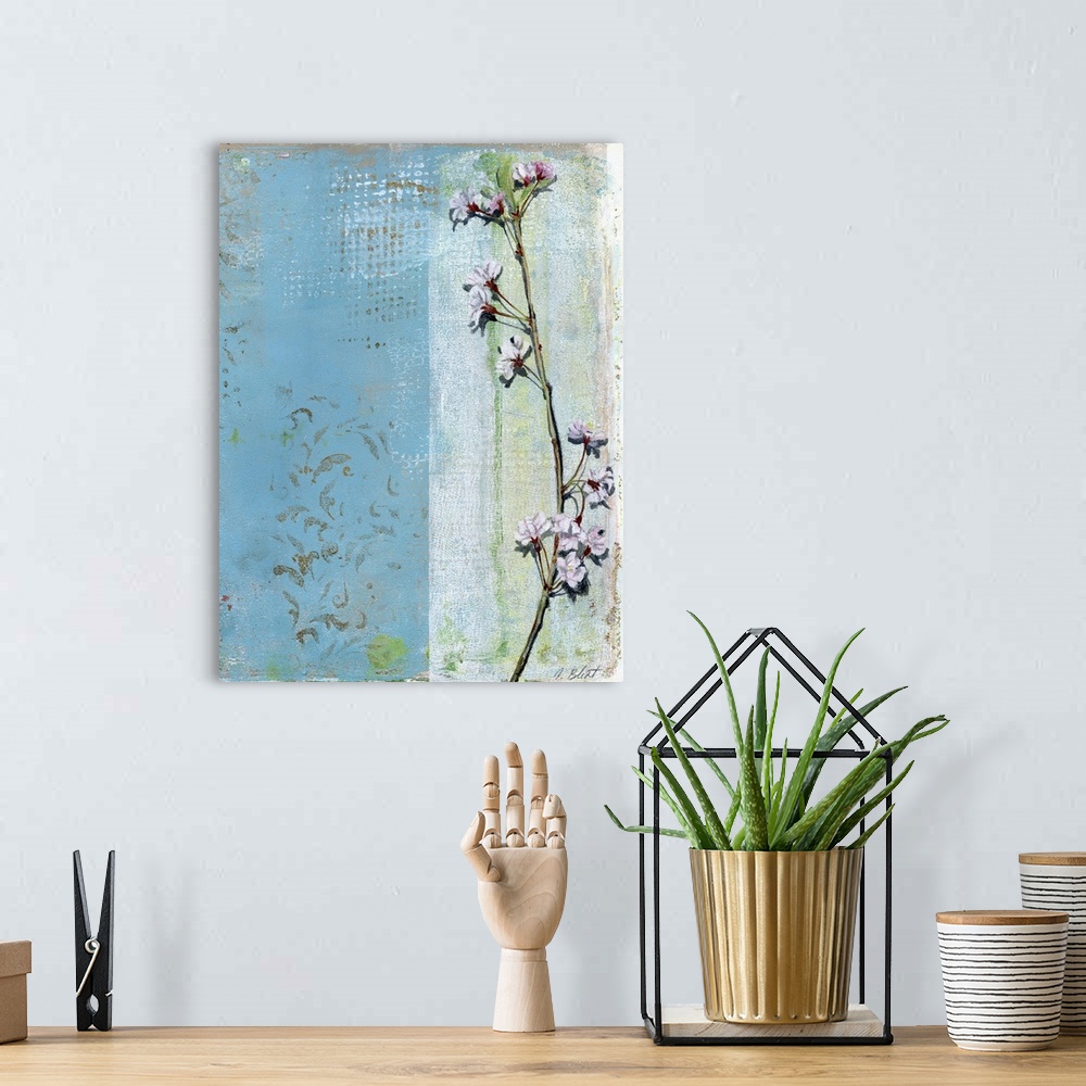 A bohemian room featuring This contemporary artwork features a thin branch with blossoming flowers positioned over a varied...