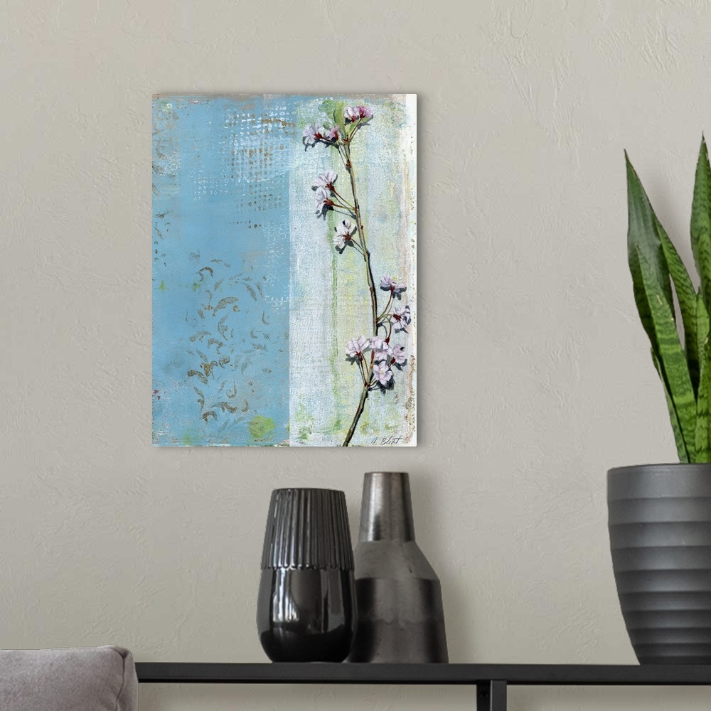 A modern room featuring This contemporary artwork features a thin branch with blossoming flowers positioned over a varied...
