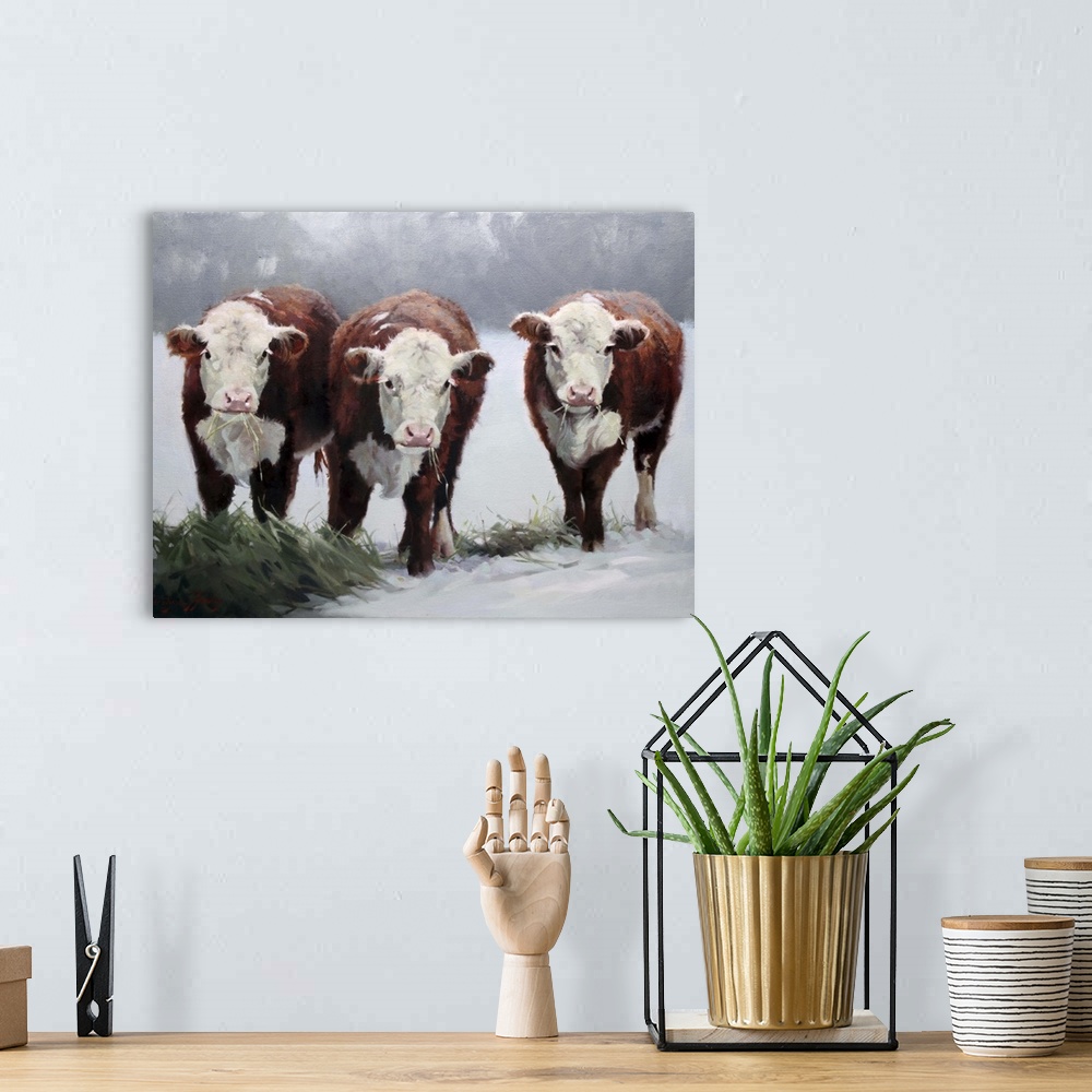 A bohemian room featuring Contemporary artwork of three brown and white cows in the snow.