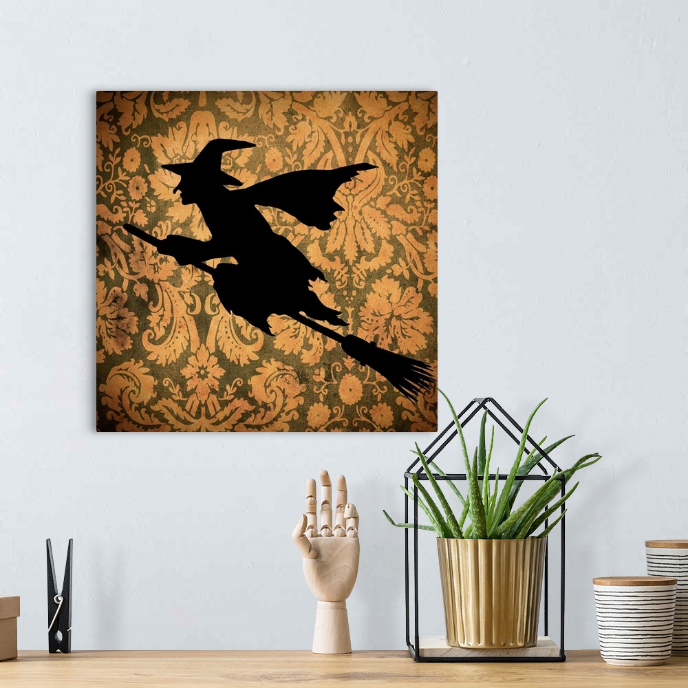 A bohemian room featuring Silhouette of a witch on an orange floral background.