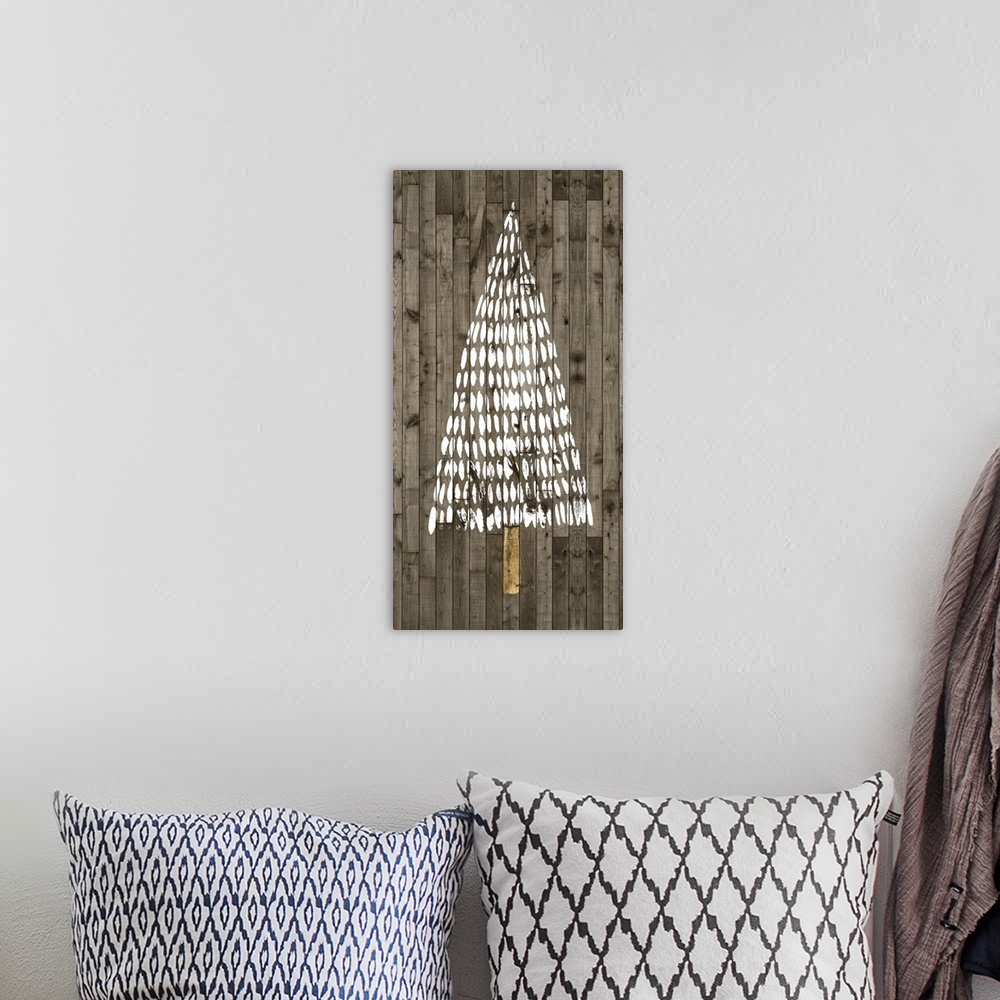 A bohemian room featuring A decorative design of a simple Christmas tree in white with gold accents on a wood backdrop.