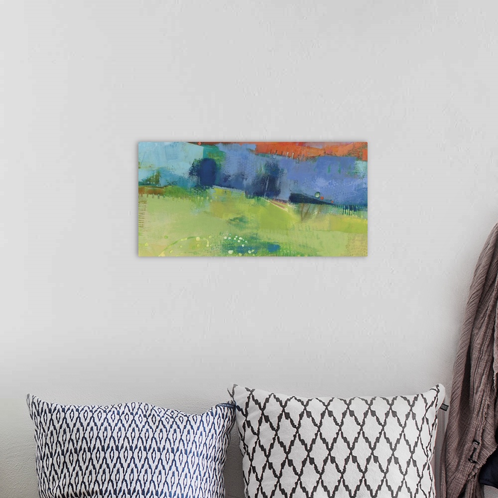 A bohemian room featuring Abstract modern art print in cheerful shades of blue, orange, and green.