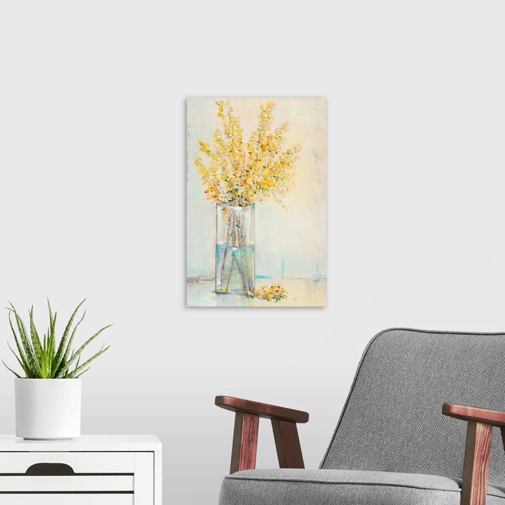 A modern room featuring Yellow flowers sitting in a rectangular glass vase.