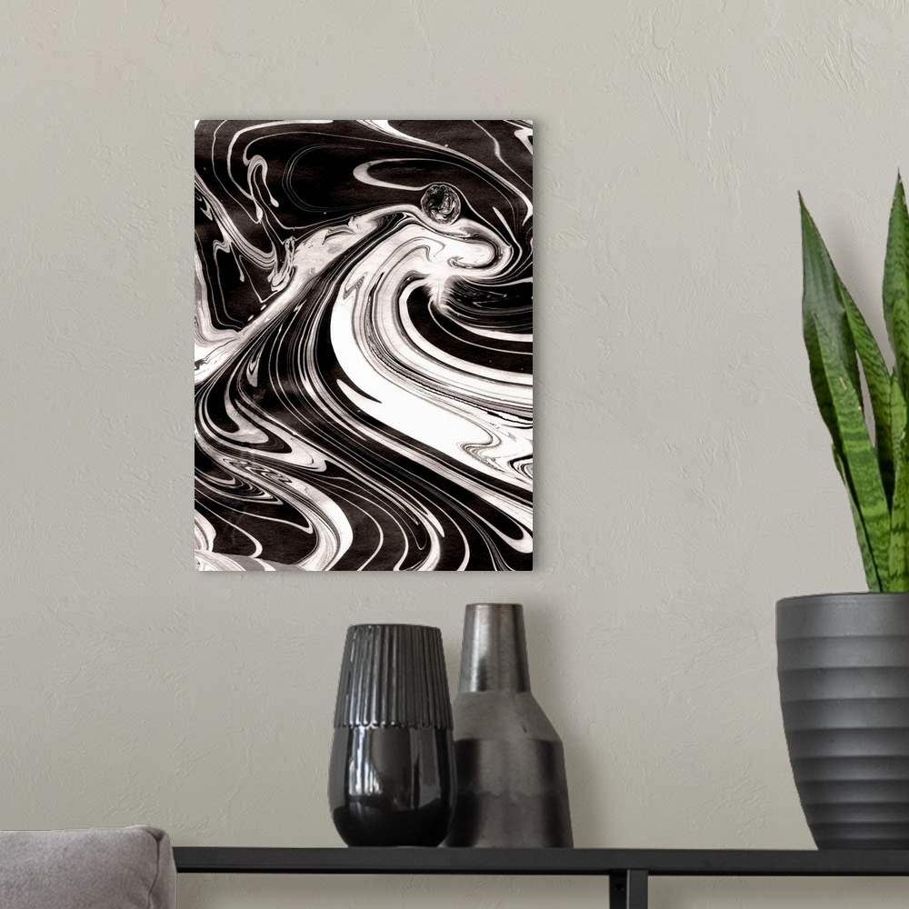 A modern room featuring Abstract artwork of black and white paint swirled around in rippling patterns.