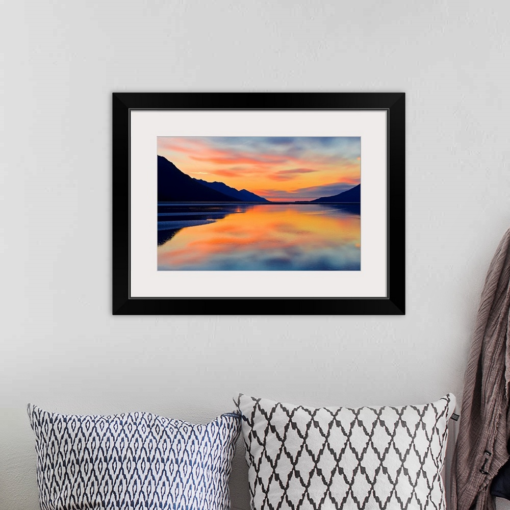 A bohemian room featuring Expansive photograph of the Turnagain Arm in the Cook Inlet in Alaska (AK) during sunset. Calm wa...