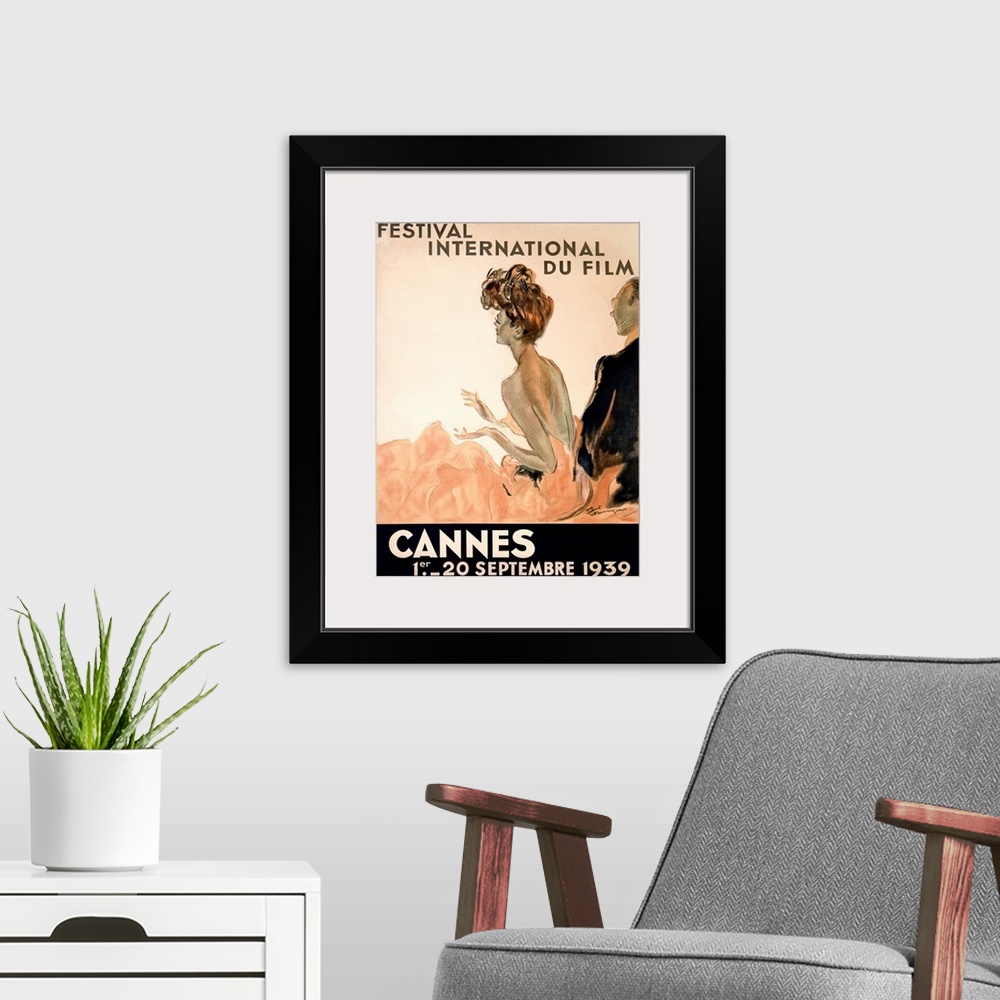 A modern room featuring Vintage advertising poster from 1939 showing a woman in a gown and a man in a tuxedo watching a f...