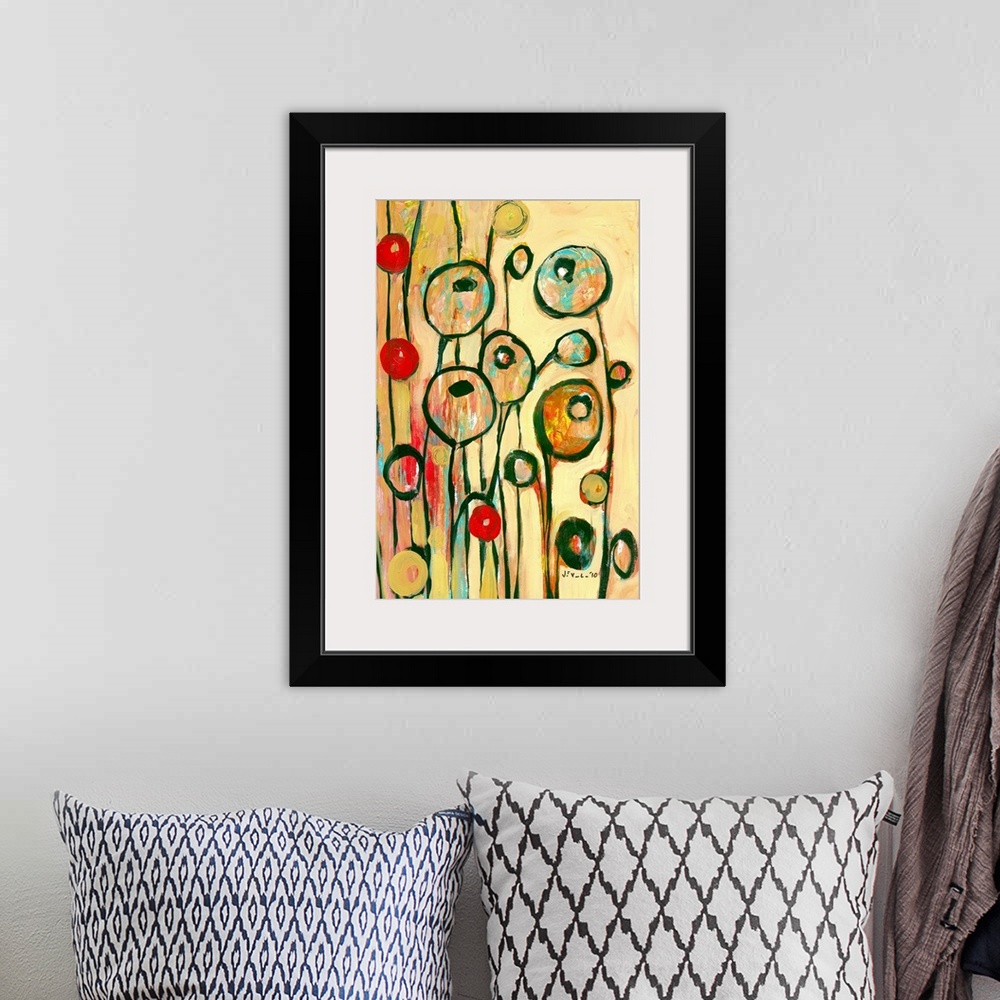 A bohemian room featuring Large, portrait contemporary art of circular, modern poppy shapes springing upward on a golden, w...