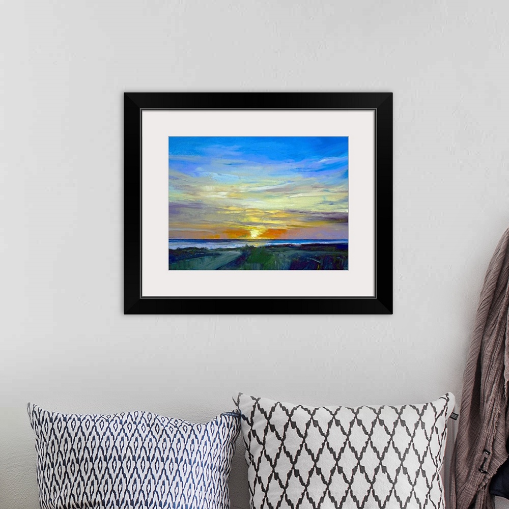 A bohemian room featuring Oil painting of sunset over water with land in the foreground.