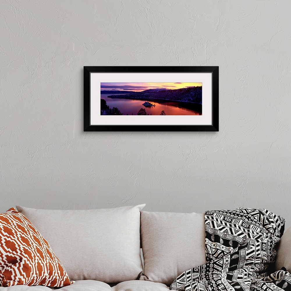 A bohemian room featuring Panoramic photograph of bay at sunset twisting through snow dusted mountains and trees.
