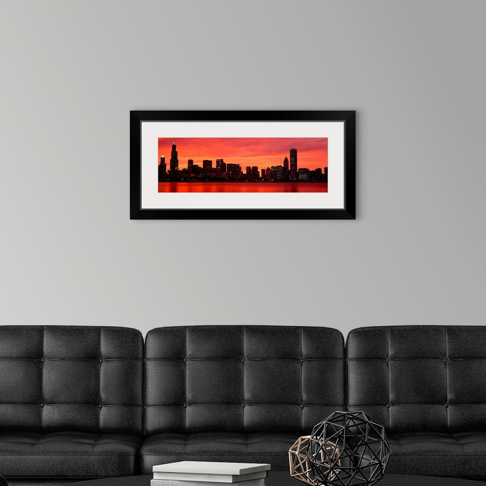 A modern room featuring Giant landscape wall picture of the Chicago skyline at dusk, reflecting in the waters of Lake Mic...