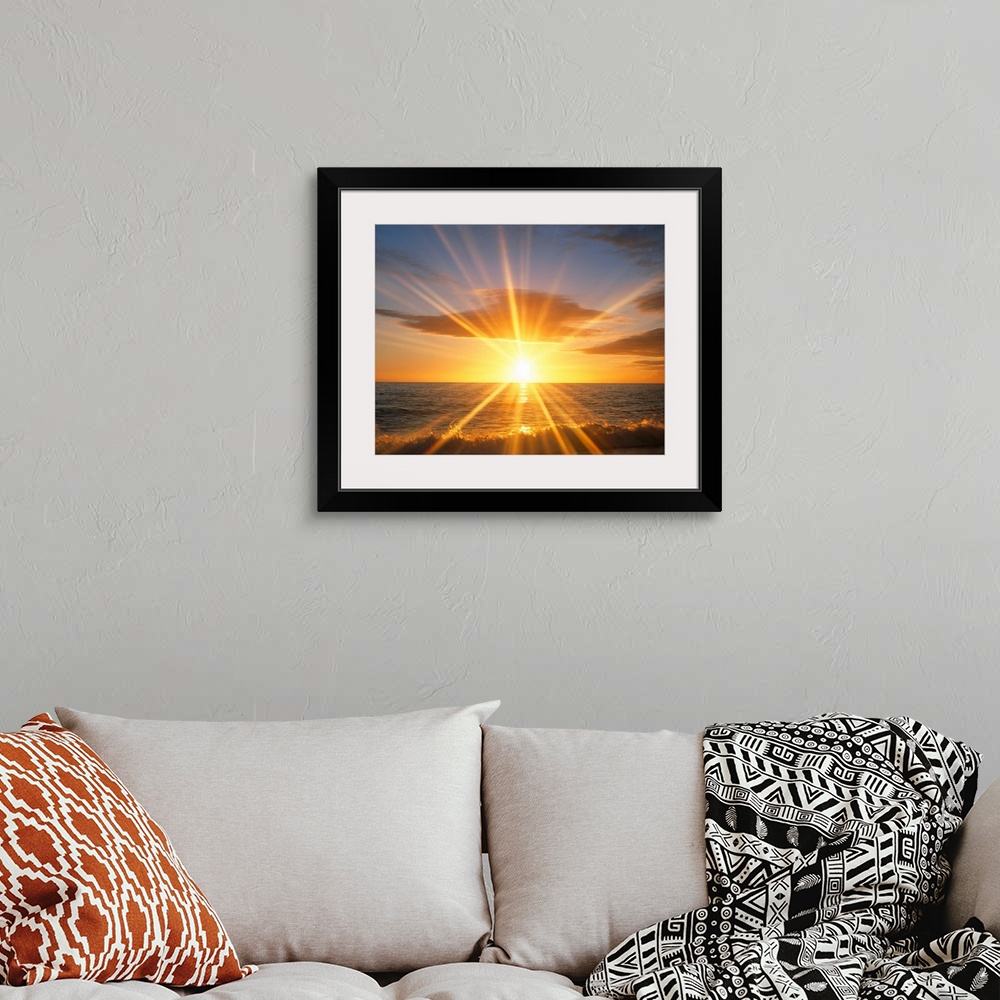 A bohemian room featuring Giant photograph of a bright sunset reflecting onto an ocean as the waves crash against a sandy b...